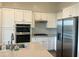 Modern kitchen featuring white cabinetry, stainless steel appliances, and a stylish backsplash at 20952 E Via Del Sol --, Queen Creek, AZ 85142
