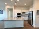 Modern kitchen with stainless steel appliances, a central island, and white cabinets for a sleek look at 20952 E Via Del Sol --, Queen Creek, AZ 85142