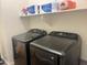 Laundry room with front loading washer and dryer, and storage on shelves at 20952 E Via Del Sol --, Queen Creek, AZ 85142