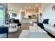 Bright living room with an open layout, white furniture, and modern finishes, adjacent to kitchen at 20952 E Via Del Sol --, Queen Creek, AZ 85142