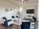 Cozy living room with sleek furniture, decorative art, and a ceiling fan at 20952 E Via Del Sol --, Queen Creek, AZ 85142