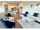 Bright living room showcases open-concept design and seamlessly connects to the modern kitchen at 20952 E Via Del Sol --, Queen Creek, AZ 85142
