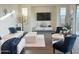 Comfortable living room with modern decor, a white sofa, and stylish accent chairs at 20952 E Via Del Sol --, Queen Creek, AZ 85142