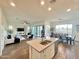Spacious open concept living area with kitchen island, living room, and dining space, featuring modern decor at 20952 E Via Del Sol --, Queen Creek, AZ 85142
