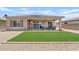 Charming backyard with green turf, gravel landscaping, covered patio, and outdoor seating area at 23038 E Twilight Dr, Queen Creek, AZ 85142