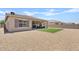 Home's backyard, zero-scaped, a covered patio with furniture, and artificial turf at 23038 E Twilight Dr, Queen Creek, AZ 85142