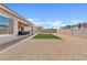 Wide backyard, featuring a zero-scaping design, grass rectangle and an enclosed block wall at 23038 E Twilight Dr, Queen Creek, AZ 85142
