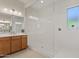Well-lit bathroom featuring a large, modern shower and a spacious vanity at 23038 E Twilight Dr, Queen Creek, AZ 85142