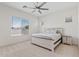 Cozy bedroom featuring a ceiling fan, bright natural light, and a comfortable bed at 23038 E Twilight Dr, Queen Creek, AZ 85142