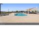 A modern community pool area with lounge chairs, sunshades, and tables for residents at 23038 E Twilight Dr, Queen Creek, AZ 85142
