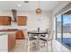 Bright dining area features a round table, wood cabinets, and sliding glass doors leading to the backyard at 23038 E Twilight Dr, Queen Creek, AZ 85142