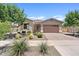 Charming single-story home featuring manicured desert landscaping and a two-car garage at 23038 E Twilight Dr, Queen Creek, AZ 85142