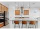 Bright kitchen with stainless steel appliances, a large island, and modern pendant lights at 23038 E Twilight Dr, Queen Creek, AZ 85142