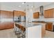 Well-lit kitchen with stainless steel appliances, a center island, and pendant lighting at 23038 E Twilight Dr, Queen Creek, AZ 85142
