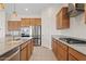 Well-lit kitchen with stainless steel appliances, a center island, and pendant lighting at 23038 E Twilight Dr, Queen Creek, AZ 85142