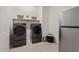 Well-equipped laundry room with modern washer, dryer, and shelving for organized storage at 23038 E Twilight Dr, Queen Creek, AZ 85142
