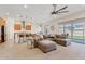 Spacious living room featuring an open-concept layout, a large sectional sofa, and sliding glass doors to the yard at 23038 E Twilight Dr, Queen Creek, AZ 85142