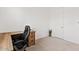 Office with carpet flooring, desk and chair, with a neutral color scheme and a door to the side at 23038 E Twilight Dr, Queen Creek, AZ 85142