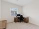 Office featuring carpet flooring, a desk, a chair, and a window with a view of the neighborhood at 23038 E Twilight Dr, Queen Creek, AZ 85142