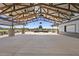 Spacious outdoor pavilion with a metal roof, concrete flooring, and comfortable seating areas at 23038 E Twilight Dr, Queen Creek, AZ 85142