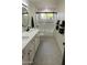 Modern bathroom with double vanity, updated fixtures and subway tile shower with glass doors at 3109 E Cholla St, Phoenix, AZ 85028