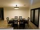 Well-lit dining room features a stylish dining table set for six, complete with elegant black chairs and modern chandelier lighting at 3109 E Cholla St, Phoenix, AZ 85028