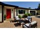 Inviting front porch with comfortable seating, a modern color scheme, and a well manicured landscape at 3109 E Cholla St, Phoenix, AZ 85028