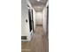 Hallway with wood flooring and doors and white cabinets for storage at 3109 E Cholla St, Phoenix, AZ 85028