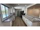 Beautiful, modern kitchen with white cabinetry, stainless appliances, and a view to the backyard pool at 3109 E Cholla St, Phoenix, AZ 85028