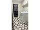 Laundry room features white appliances, black door, and stylish hexagon patterned floor tiles at 3109 E Cholla St, Phoenix, AZ 85028