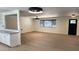 Open-concept living space featuring modern light fixtures and seamlessly connecting to the kitchen through a stylish breakfast bar at 3109 E Cholla St, Phoenix, AZ 85028