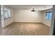 Spacious living area with light wood floors, an open design to the kitchen, and neutral paint, creating a bright and airy atmosphere at 3109 E Cholla St, Phoenix, AZ 85028