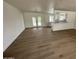 Open living room with wood-style floors, seamlessly connecting to the outdoor patio through elegant glass doors, and providing easy access to the kitchen at 3109 E Cholla St, Phoenix, AZ 85028