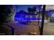 Evening shot of a backyard pool with a basketball hoop and a fire pit at 3109 E Cholla St, Phoenix, AZ 85028