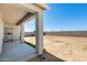 Covered back porch with a view of a spacious dirt backyard at 35816 W San Ildefanso Ave, Maricopa, AZ 85138