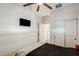 Bedroom with a ceiling fan and a tv on the wall at 35816 W San Ildefanso Ave, Maricopa, AZ 85138