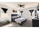 Inviting bedroom features a ceiling fan, three windows, and a cozy bed at 35816 W San Ildefanso Ave, Maricopa, AZ 85138
