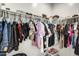 Walk-in closet with clothing rack, shelving, and a variety of shoes and clothes at 35816 W San Ildefanso Ave, Maricopa, AZ 85138