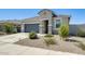 Single Gathering house boasting a desert landscaped yard, gray garage door and well-kept lawn at 35816 W San Ildefanso Ave, Maricopa, AZ 85138