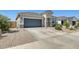 Attractive home with a large garage, desert landscaping, and a well-maintained lawn for a welcoming curb appeal at 35816 W San Ildefanso Ave, Maricopa, AZ 85138