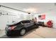 Spacious two car garage with an American flag and lots of room for storage at 35816 W San Ildefanso Ave, Maricopa, AZ 85138