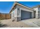 Single Gathering house boasts a desert landscaped yard and gray garage door at 35816 W San Ildefanso Ave, Maricopa, AZ 85138