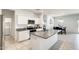 Bright kitchen features white cabinets, stainless appliances, granite countertops and an island with sink at 35816 W San Ildefanso Ave, Maricopa, AZ 85138
