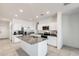 Large kitchen featuring white cabinets, stainless steel appliances and an island with a sink at 35816 W San Ildefanso Ave, Maricopa, AZ 85138