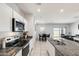 Bright kitchen with granite countertops, stainless steel appliances, and white cabinetry offering a clean and modern design at 35816 W San Ildefanso Ave, Maricopa, AZ 85138