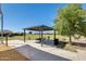 Community picnic area with shade structure, picnic table, and grill at 35816 W San Ildefanso Ave, Maricopa, AZ 85138