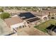 Desert home featuring solar panels, a covered patio, and desert landscaping at 3718 N Briere Ct, Buckeye, AZ 85396