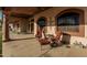 Covered back patio with comfortable seating and decorative accents perfect for outdoor relaxation at 3718 N Briere Ct, Buckeye, AZ 85396