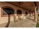 Relaxing back porch area with rocking chairs, ceiling fans and columns at 3718 N Briere Ct, Buckeye, AZ 85396