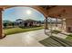 A covered patio with views of the lush backyard with pool, gazebo, and desert landscape at 3718 N Briere Ct, Buckeye, AZ 85396
